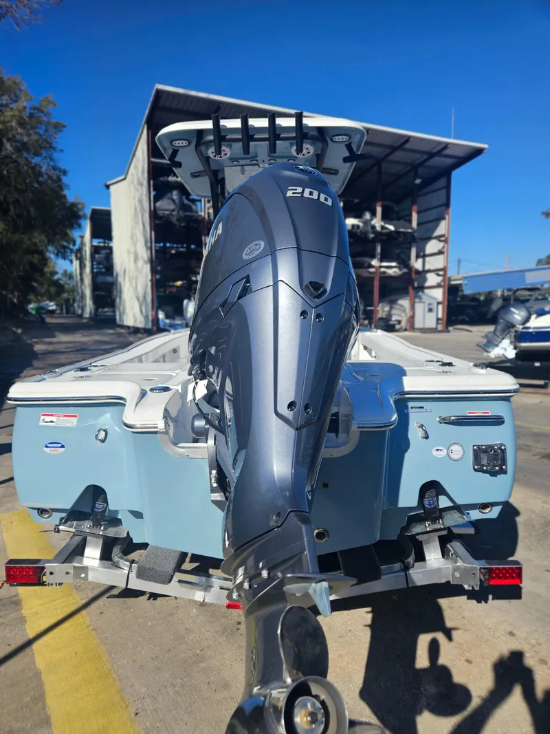 Slide: The Image of 2026 Sea Hunt BX 22 BR boat with Yamaha 200 engine, parked outdoors. - 3