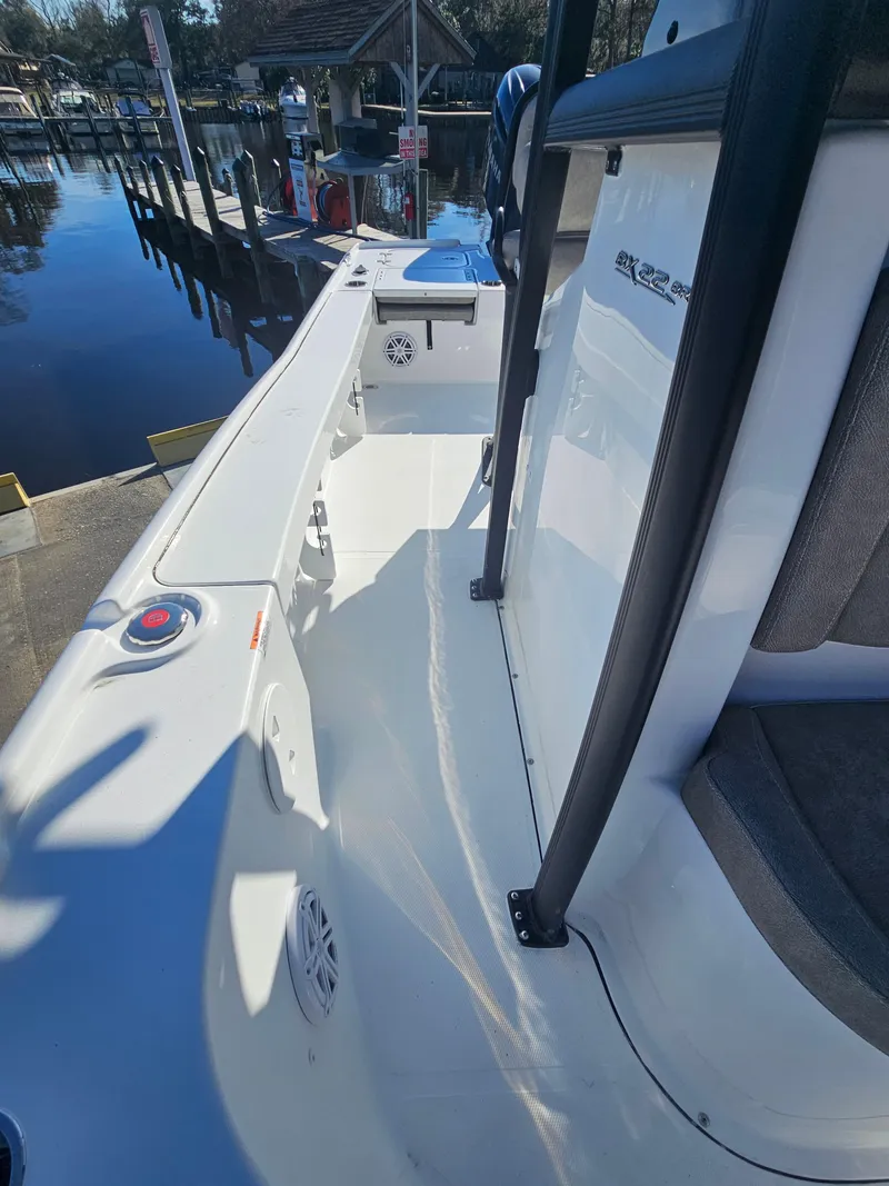 Slide: The Image of 2026 Sea Hunt BX 22 BR boat interior, featuring sleek design and modern amenities at a dock. - 31