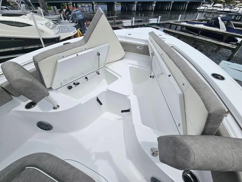 Slide: The Image of 2025 Sea Hunt Ultra 219 boat interior with cushioned seating and storage compartments. - 17
