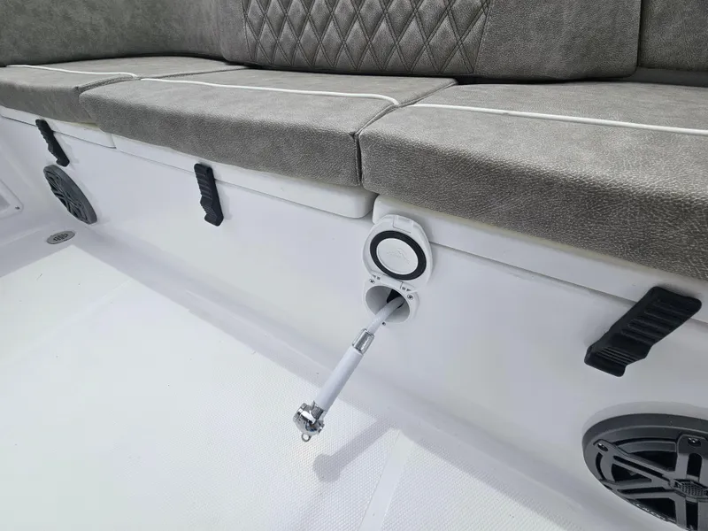 Slide: The Image of 2025 Sea Hunt Ultra 219 boat interior with cushioned seating and rod holder. - 23