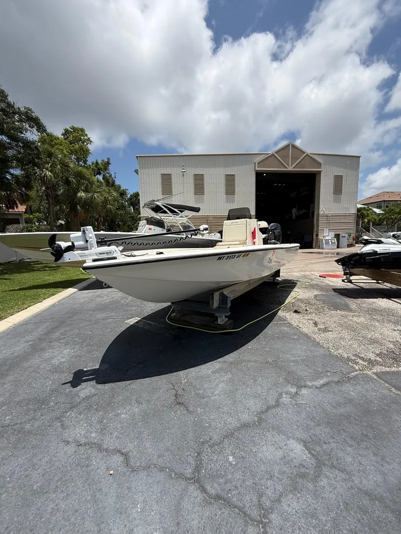 Slide: The Image of 2017 Yellowfin 24 Bay CE boat on trailer outside a large garage. - 1