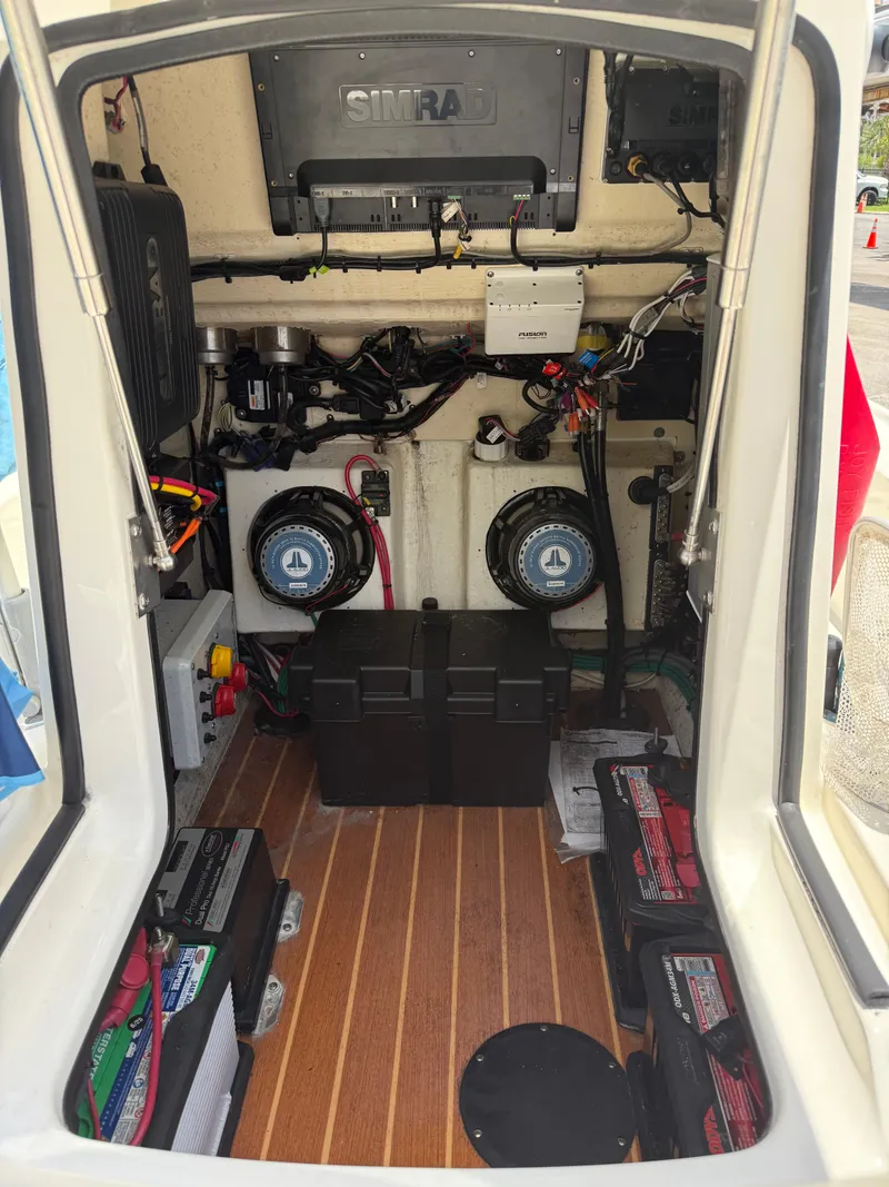 Slide: The Image of 2017 Yellowfin 24 Bay CE boat interior with electronic equipment and wiring. - 12