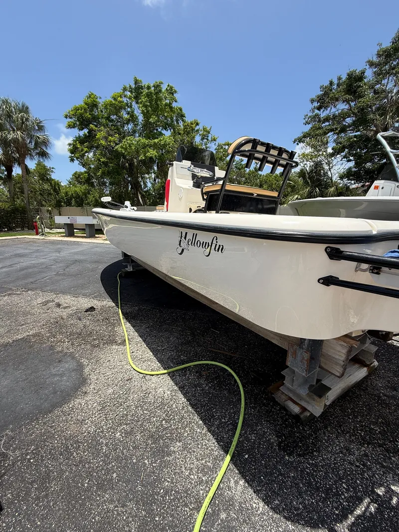 Slide: The Image of 2017 Yellowfin 24 Bay CE boat on trailer, parked outdoors under clear blue sky. - 3