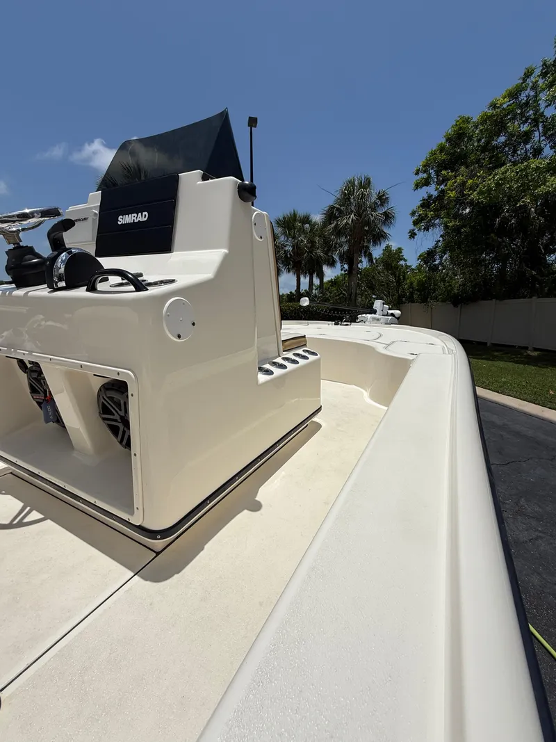 Slide: The Image of 2017 Yellowfin 24 Bay CE boat with console, outdoors under clear blue sky. - 6