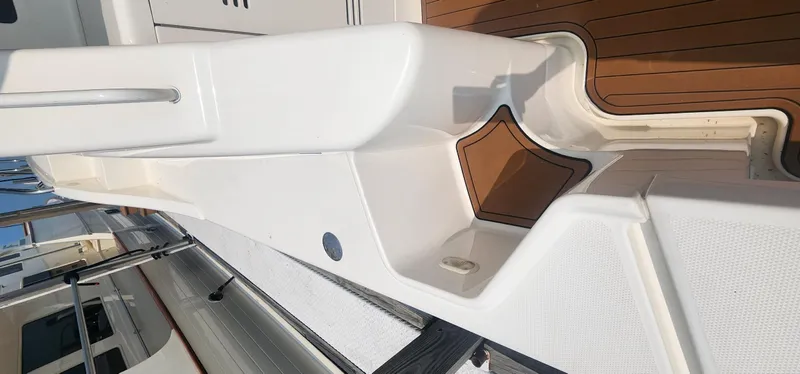 Slide: The Image of 2004 Silverton 48 Convertible yacht deck with white and wood accents. - 10