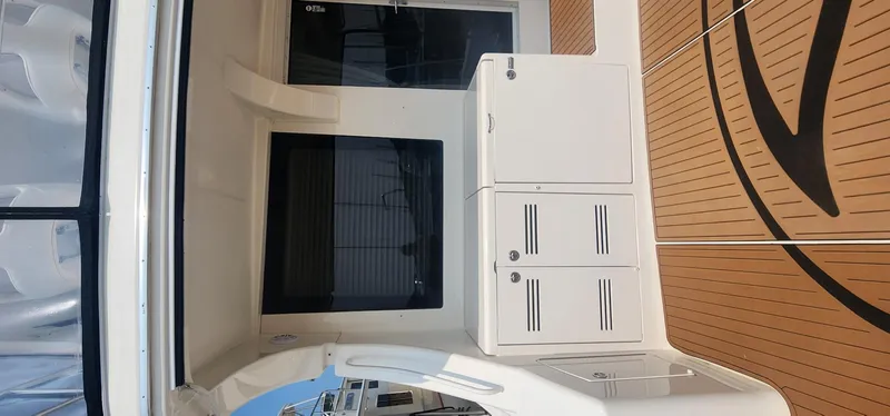 Slide: The Image of 2004 Silverton 48 Convertible yacht interior with white cabinetry and wooden flooring. - 11