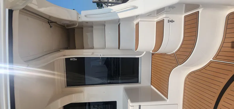 Slide: The Image of 2004 Silverton 48 Convertible yacht interior with sleek white and wood design. - 12