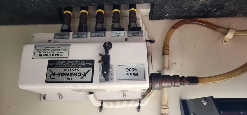 Slide: The Image of Oil change system in a 2004 Silverton 48 Convertible boat engine room. - 19