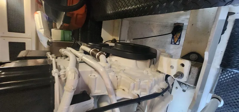 Slide: The Image of Engine room of a 2004 Silverton 48 Convertible yacht, showcasing mechanical components. - 23