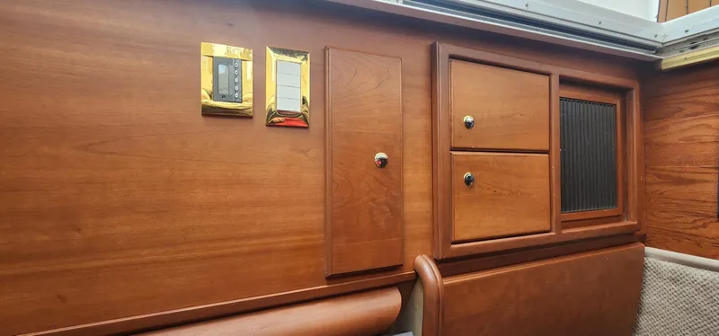 Slide: The Image of Interior of 2004 Silverton 48 Convertible yacht with wooden cabinetry and control panels. - 25