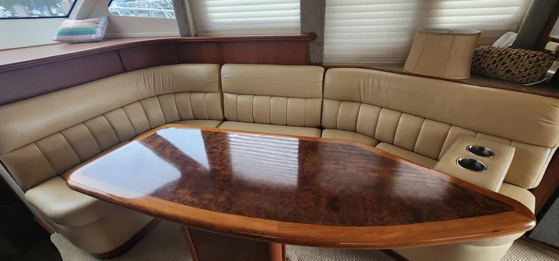 Slide: The Image of Luxurious interior of 2004 Silverton 48 Convertible yacht with plush seating and polished wood table. - 27
