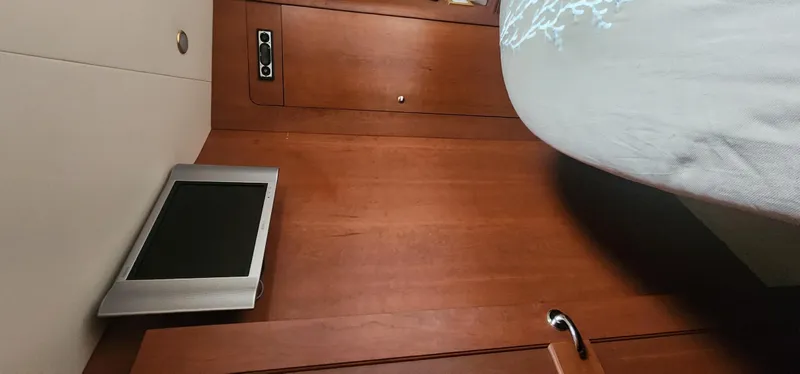 Slide: The Image of 2004 Silverton 48 Convertible interior with wood paneling and mounted screen. - 31