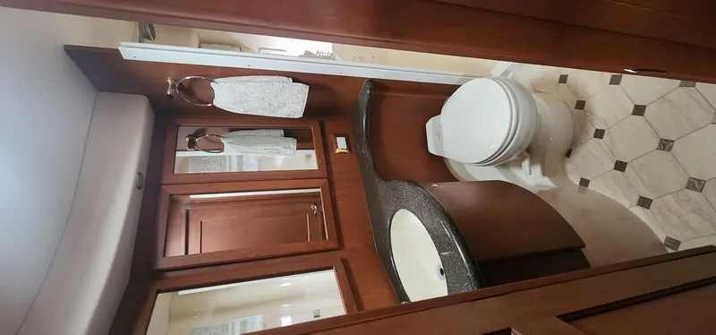 Slide: The Image of Luxurious bathroom in 2004 Silverton 48 Convertible yacht with wood cabinetry and modern fixtures. - 32