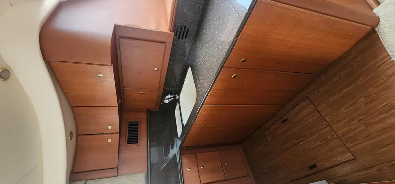 Slide: The Image of 2004 Silverton 48 Convertible yacht interior with wooden cabinetry and modern design. - 39