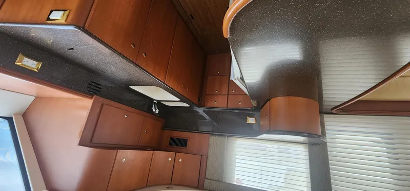 Slide: The Image of 2004 Silverton 48 Convertible yacht interior with wooden cabinetry and modern design. - 40