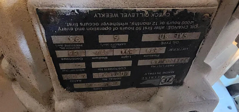 Slide: The Image of Close-up of a 2004 Silverton 48 Convertible engine label with maintenance instructions. - 41