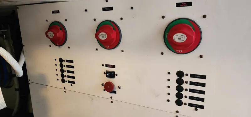 Slide: The Image of Electrical panel of a 2004 Silverton 48 Convertible boat with red switches and controls. - 44