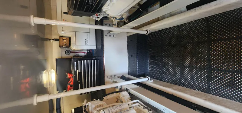 Slide: The Image of Engine room of a 2004 Silverton 48 Convertible yacht, featuring equipment and storage. - 45