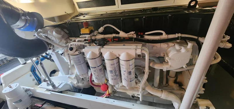 Slide: The Image of Engine room of a 2004 Silverton 48 Convertible yacht, showcasing detailed machinery. - 47