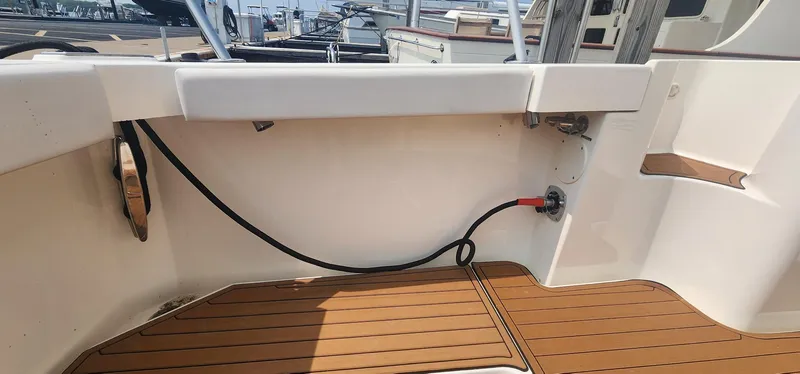 Slide: The Image of 2004 Silverton 48 Convertible yacht deck with wood finish and utility connections. - 7