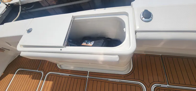 Slide: The Image of 2004 Silverton 48 Convertible boat deck with storage compartment and teak flooring. - 8