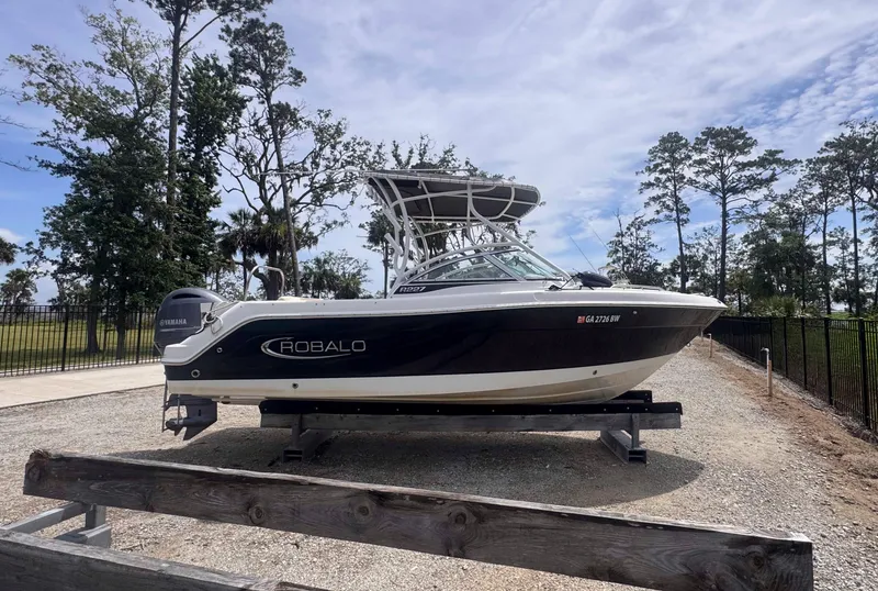 The Image of 2019 Robalo R227 Dual Console boat on trailer, parked outdoors. - 0