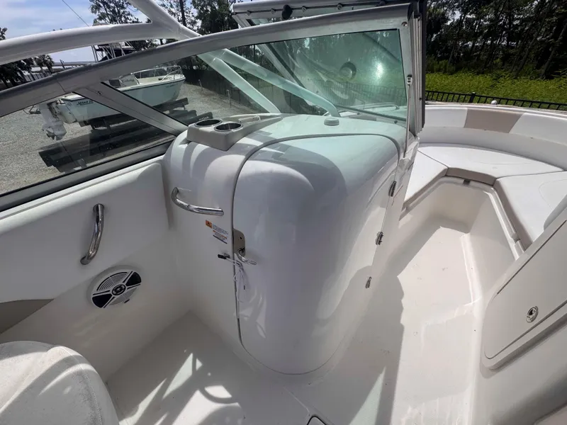 Slide: The Image of 2019 Robalo R227 Dual Console boat interior with seating and storage compartments. - 12