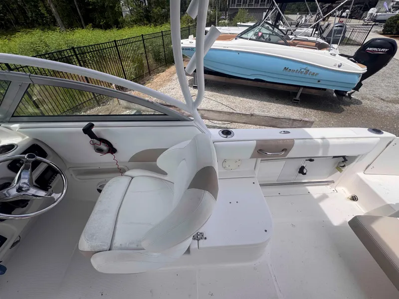 Slide: The Image of 2019 Robalo R227 Dual Console boat interior with steering wheel and seating. - 14