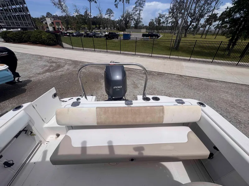 Slide: The Image of 2019 Robalo R227 Dual Console boat with 200 HP engine, parked outdoors. - 15