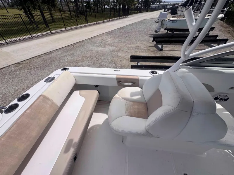 Slide: The Image of 2019 Robalo R227 Dual Console boat interior with seating and cup holders. - 16