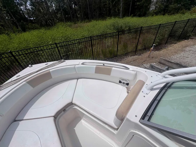 Slide: The Image of 2019 Robalo R227 Dual Console boat interior with seating and speaker, near a fenced area. - 20