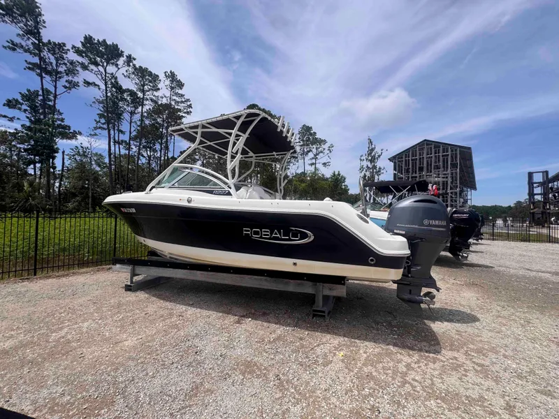 Slide: The Image of 2019 Robalo R227 Dual Console boat with Yamaha engine, parked outdoors. - 4