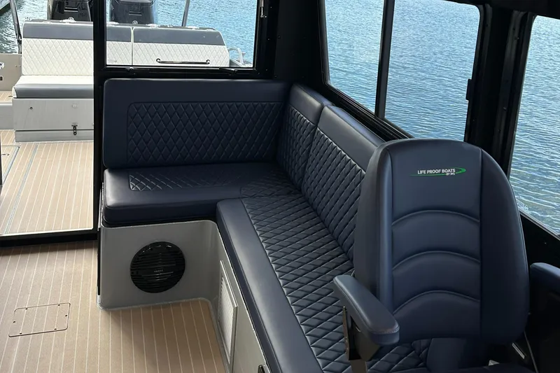 Slide: The Image of 2023 Life Proof 35 Full Cabin interior with blue quilted seating and wood flooring. - 15