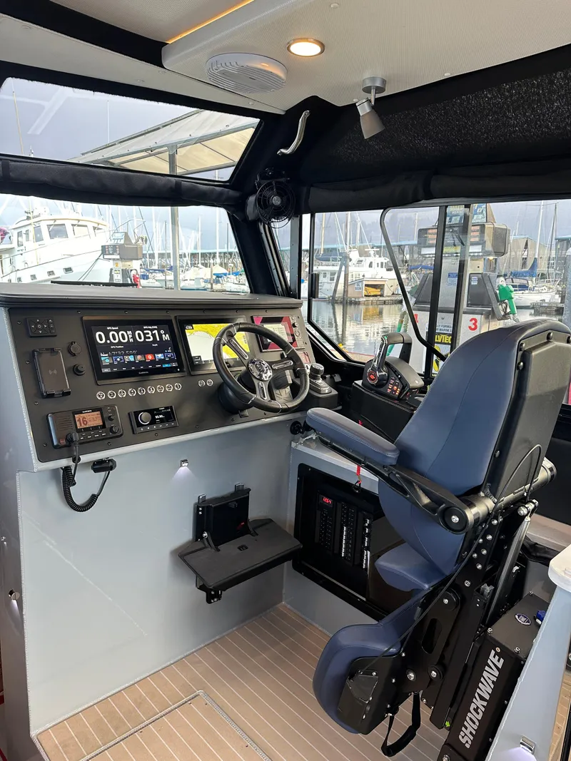 Slide: The Image of 2023 Life Proof 35 Full Cabin boat interior with advanced navigation controls. - 4