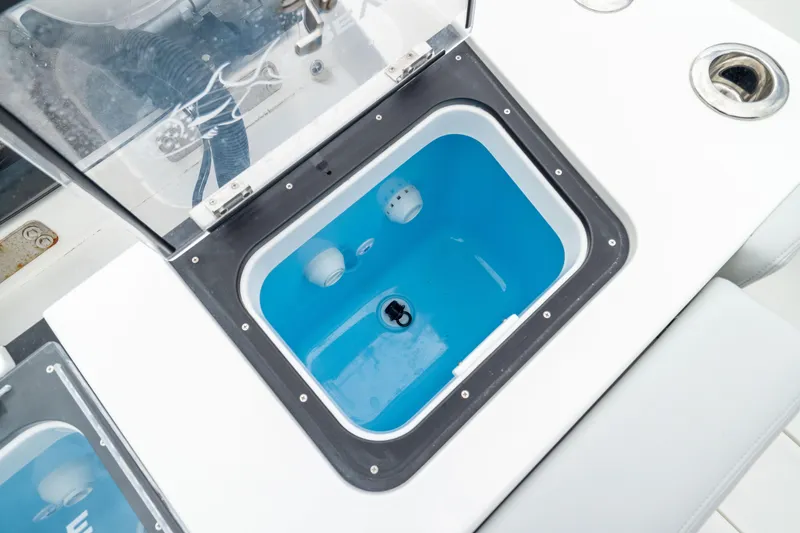 Slide: The Image of Livewell compartment on 2026 Crevalle 33 CSF boat, featuring a blue interior. - 13