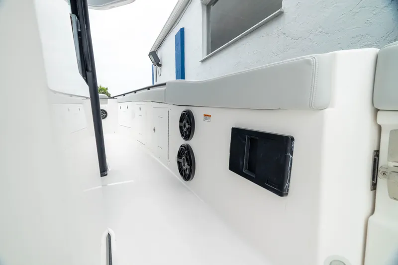 Slide: The Image of 2026 Crevalle 33 CSF boat interior with speakers and storage compartments. - 17