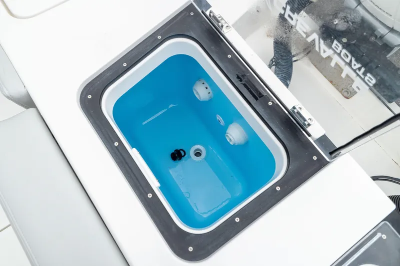 Slide: The Image of Livewell compartment on 2026 Crevalle 33 CSF boat, featuring a blue interior. - 18