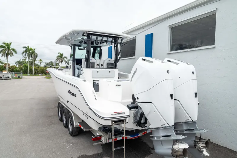 Slide: The Image of 2026 Crevalle 33 CSF boat with dual outboard engines on a trailer. - 24