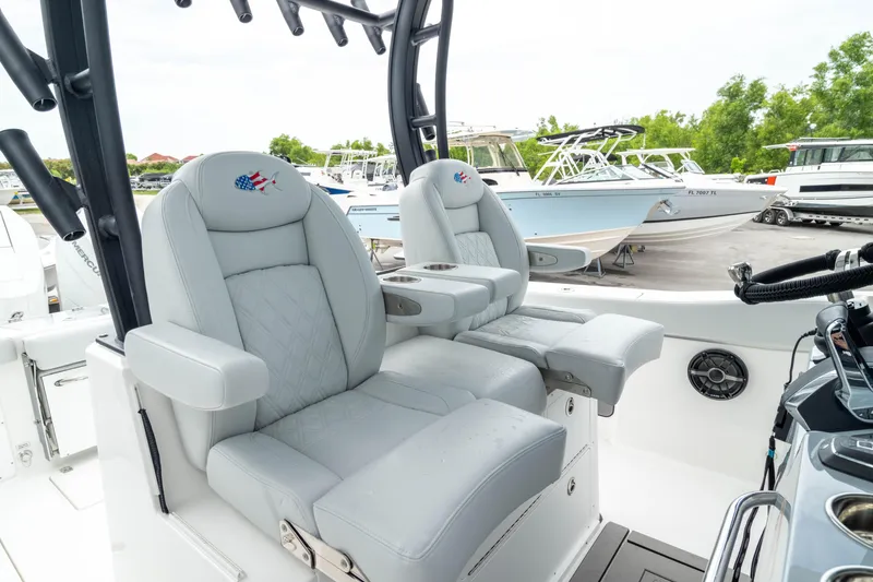 Slide: The Image of Luxury seating on 2026 Crevalle 33 CSF boat, featuring plush captain's chairs and modern design. - 32