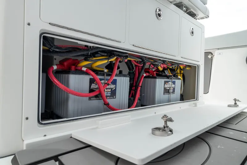 Slide: The Image of Battery compartment of 2026 Crevalle 33 CSF boat, featuring organized wiring and secure storage. - 33