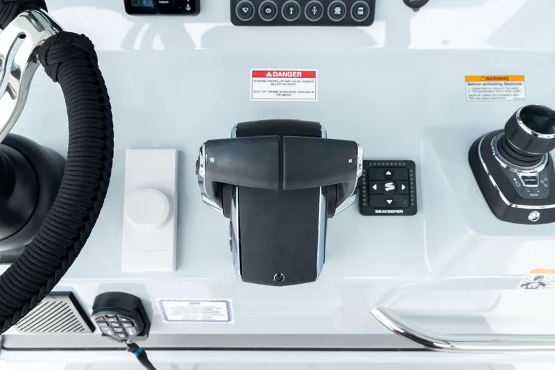 Slide: The Image of 2026 Crevalle 33 CSF boat control panel with throttle and joystick. - 44