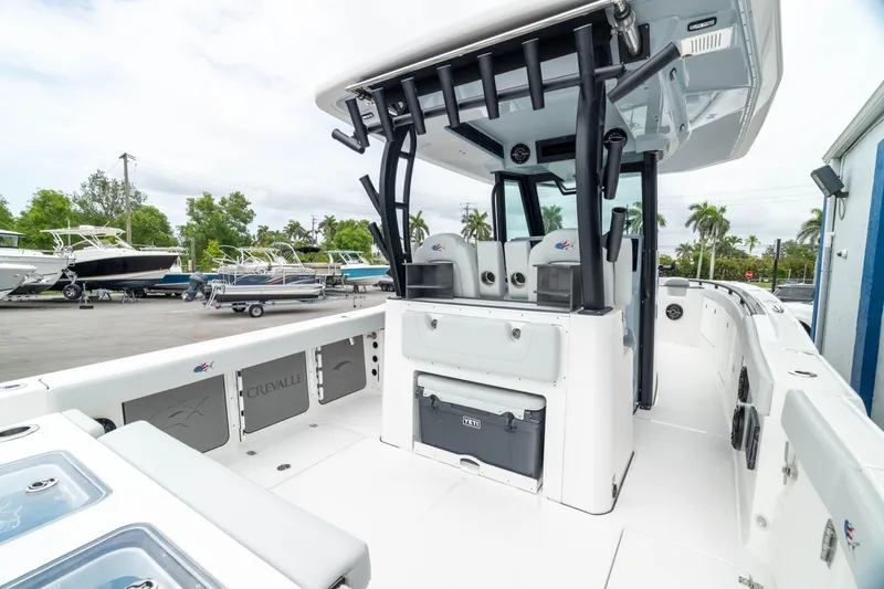 Slide: The Image of 2026 Crevalle 33 CSF boat interior with seating and storage, docked outdoors. - 8