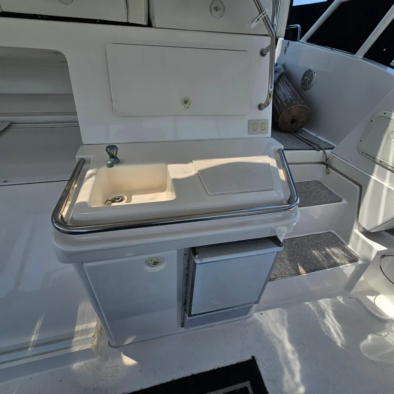 Slide: The Image of 2000 Silverton 392 Motor Yacht interior with sink and mini fridge. - 10