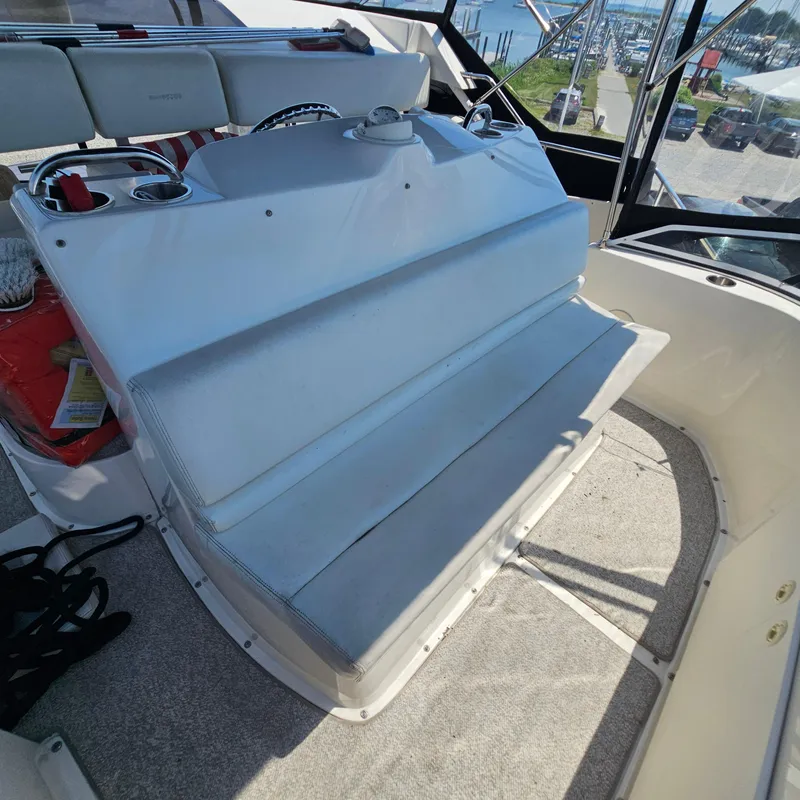 Slide: The Image of 2000 Silverton 392 Motor Yacht helm with seating, docked at marina. - 12