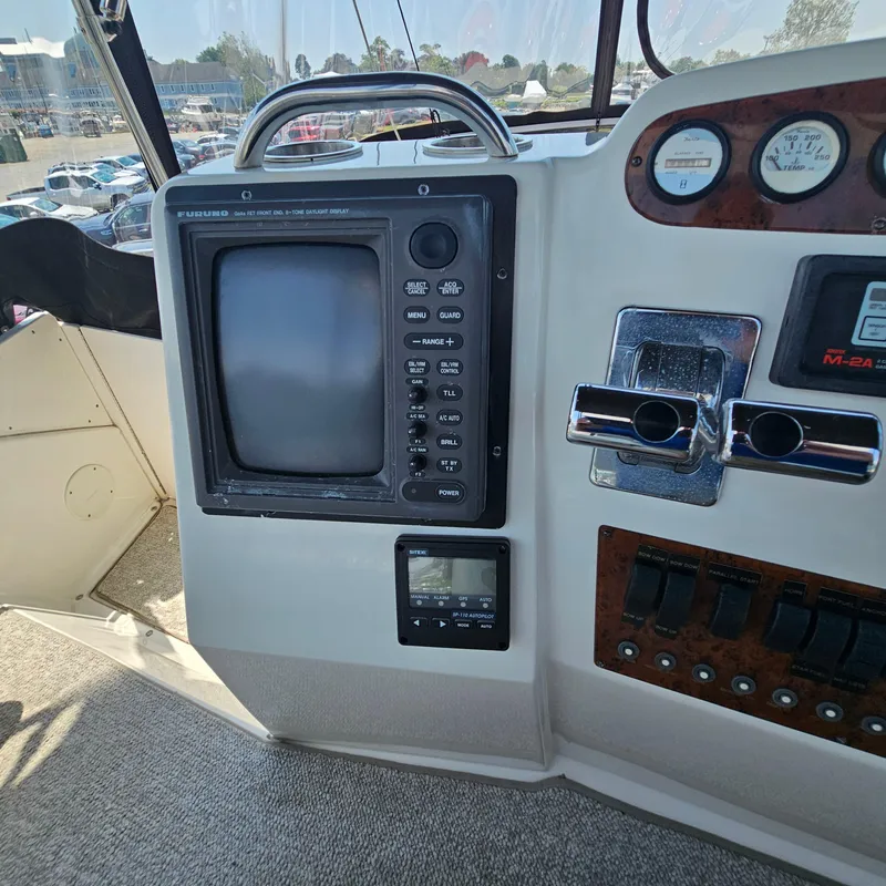 Slide: The Image of Control panel of a 2000 Silverton 392 Motor Yacht with navigation equipment. - 16