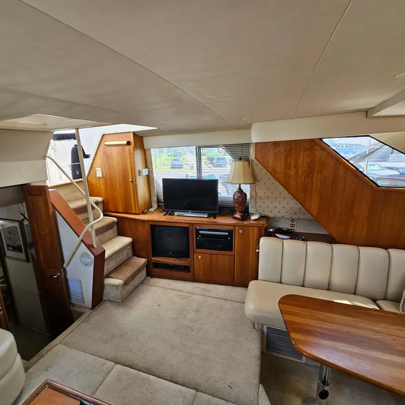 Slide: The Image of Interior of 2000 Silverton 392 Motor Yacht with cozy seating and entertainment area. - 21
