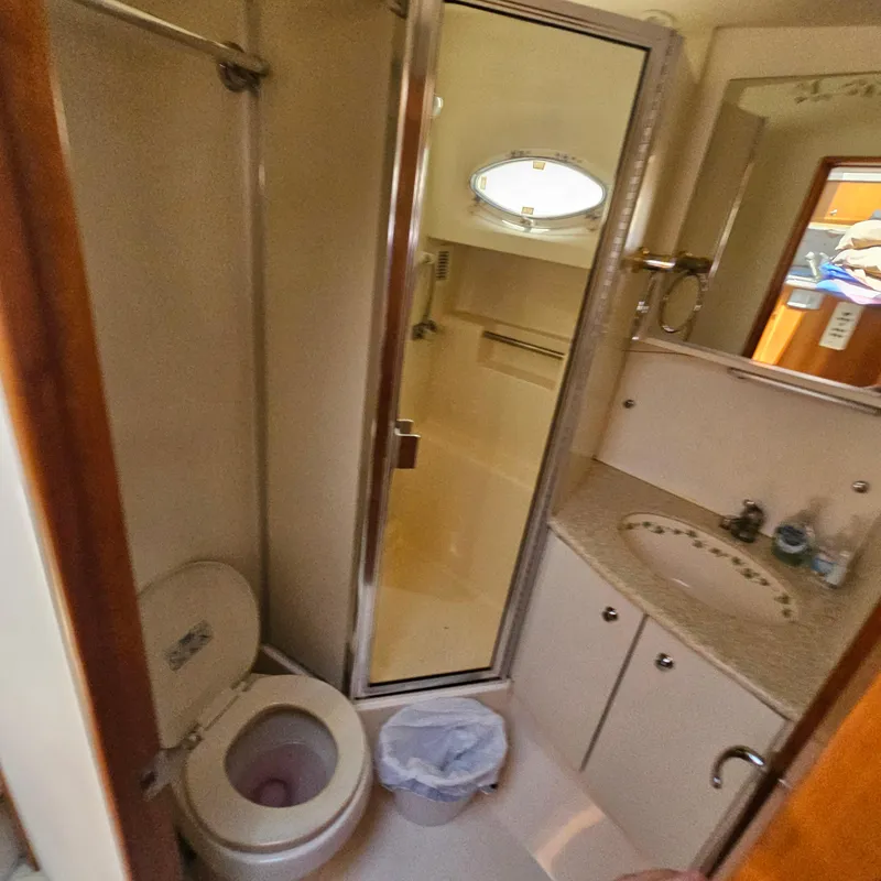 Slide: The Image of Bathroom interior of 2000 Silverton 392 Motor Yacht with shower, toilet, and sink. - 32