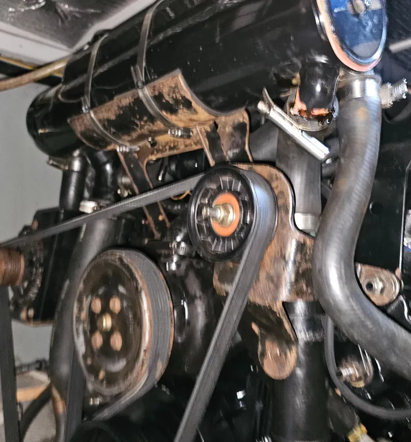 Slide: The Image of Engine components of a 2000 Silverton 392 Motor Yacht, showing belts and pulleys. - 38