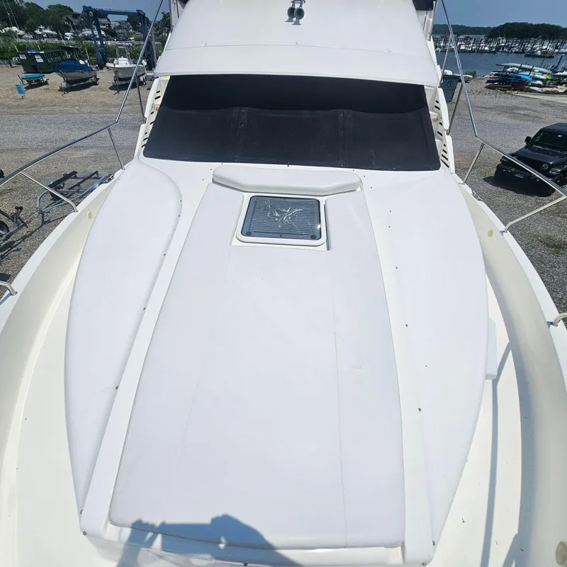 Slide: The Image of 2000 Silverton 392 Motor Yacht deck view, featuring sleek design and spacious layout. - 7