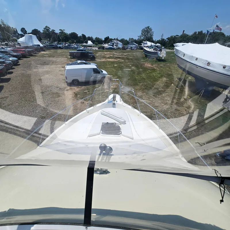 Slide: The Image of 2000 Silverton 392 Motor Yacht parked on a grassy lot with surrounding vehicles. - 9